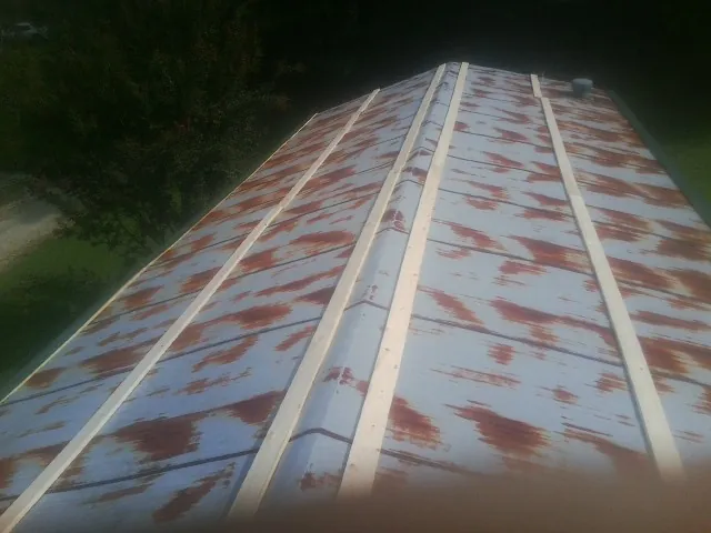 Rusted metal roof panels with new wood purlins before replacement — Storm Damage Roof Repair in Ocklawaha by Roofing Brothers