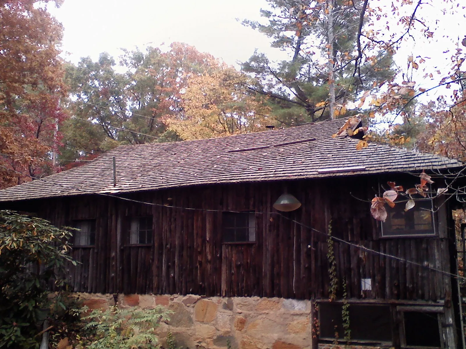 Weathered wood shake roof on a rustic board sided cabin in Ocklawaha